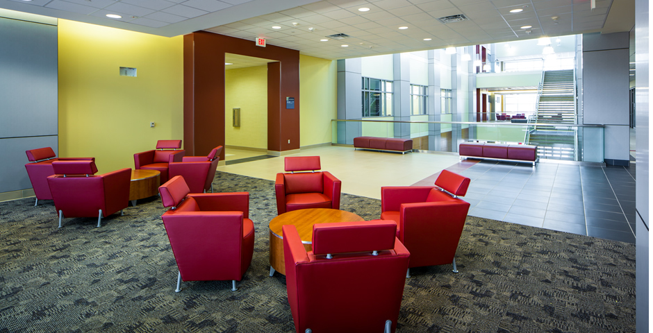 Seating area with red couches and benches inside San Jacinto College