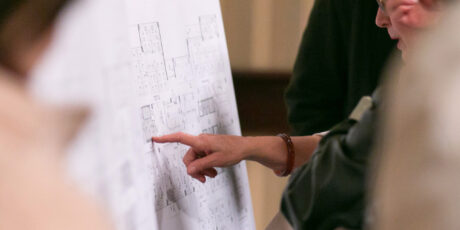 Person pointing at a floor plan