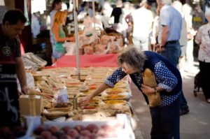 Elderly woman shopping at a farmers market