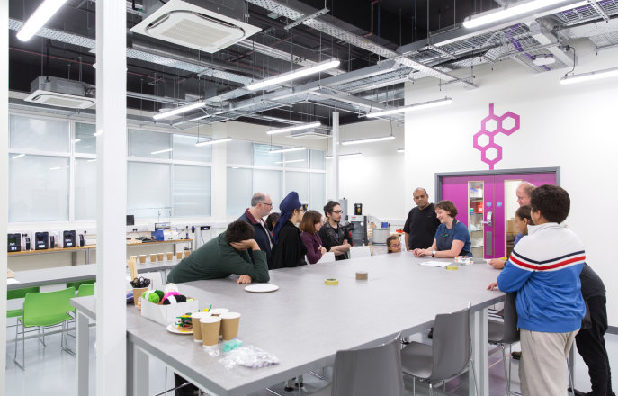 People gather around a table at the Imperial College Makerspace