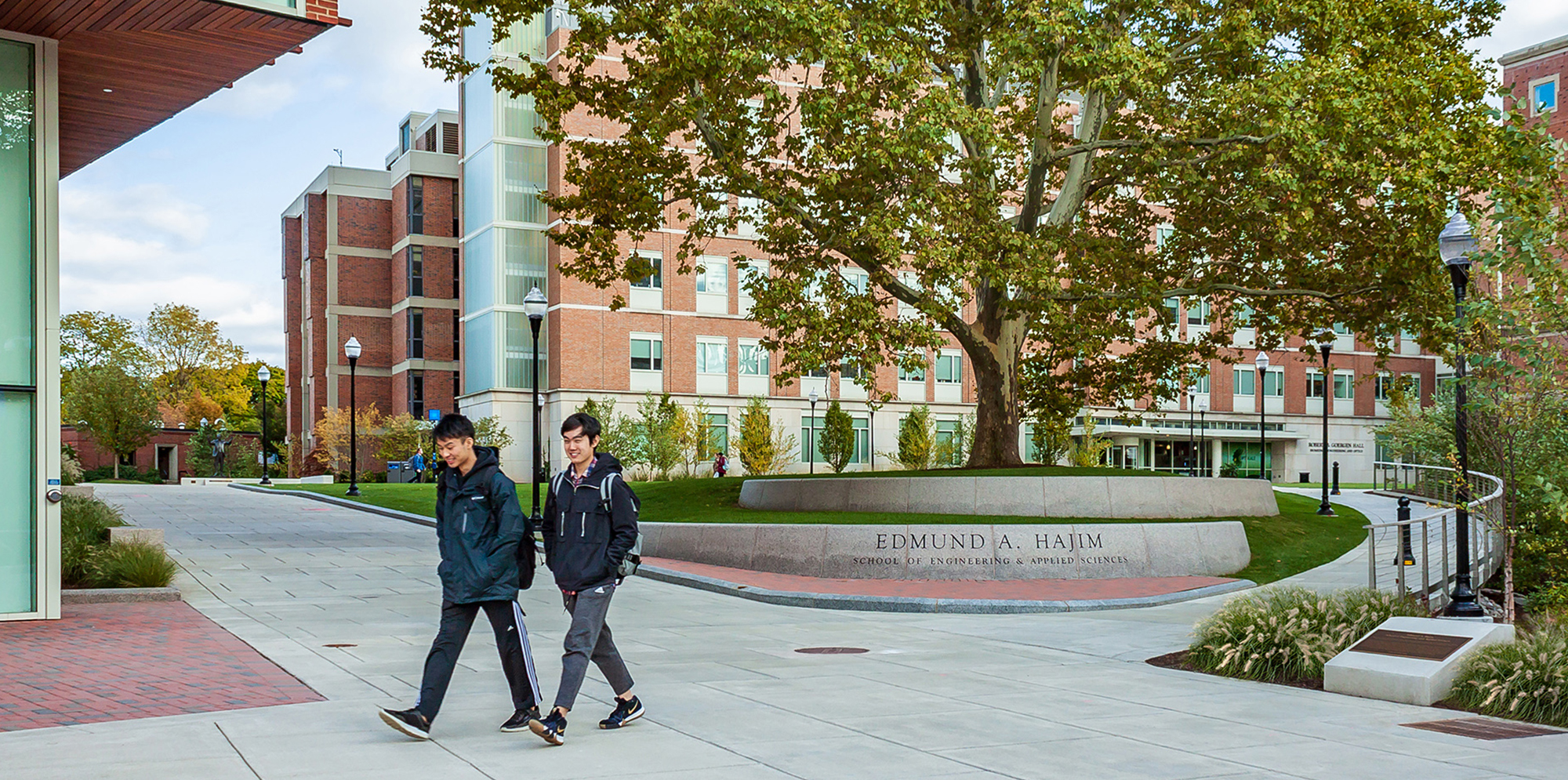 Students walking in front of the Edmund A. Hajim building in the Science and Engineering Quad at the University of Rochester
