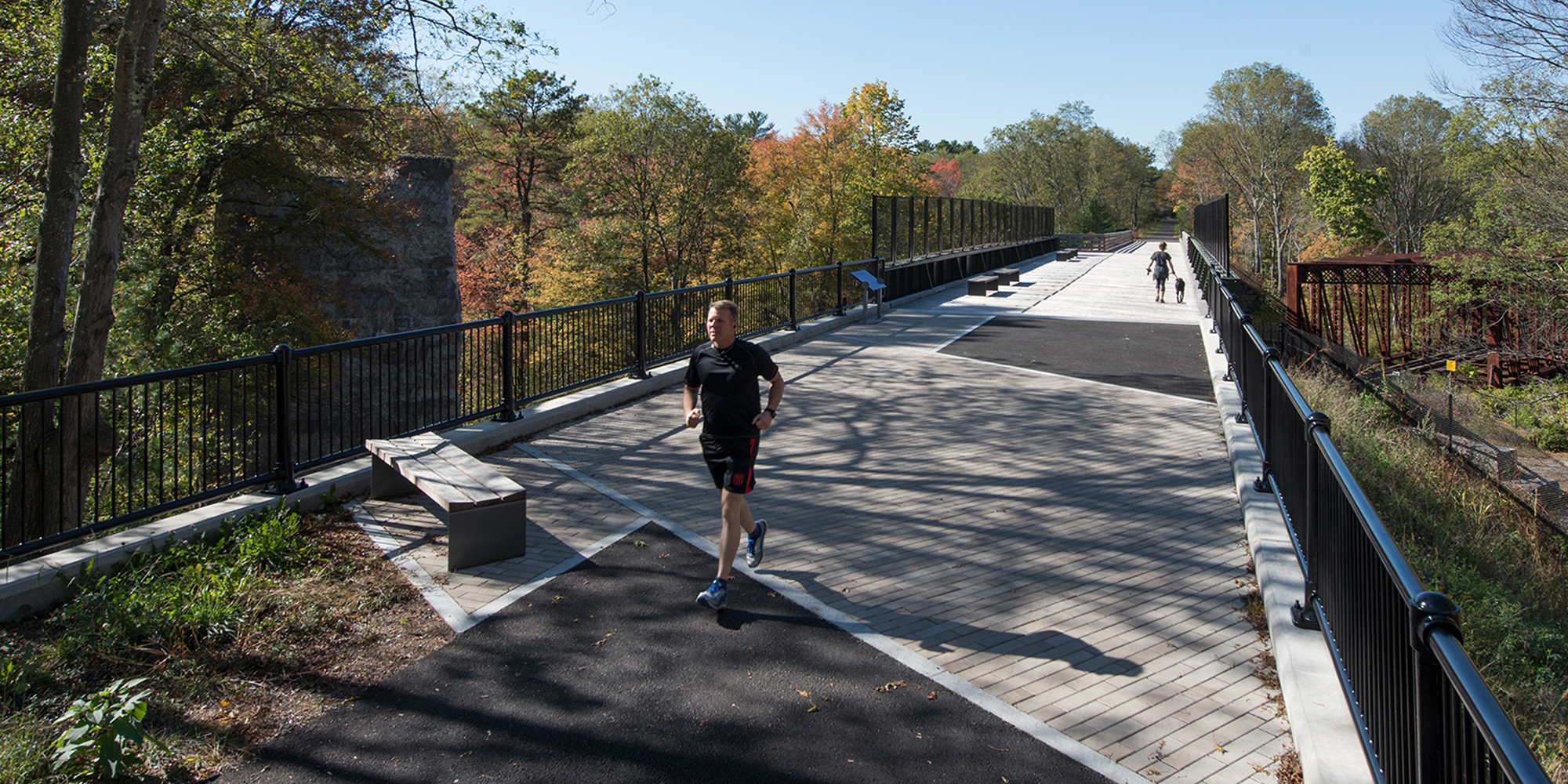 Runners along a bridge of the Blackstone River Valley Greenway