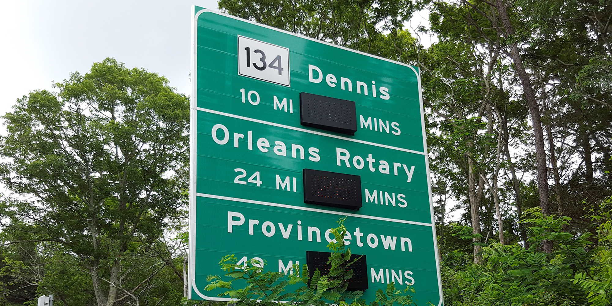 Highway sign showing number of minutes it takes to travel to next exit
