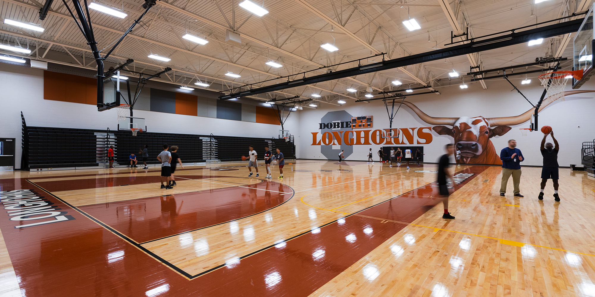 Students playing basketball inside J Frank Dobie High School