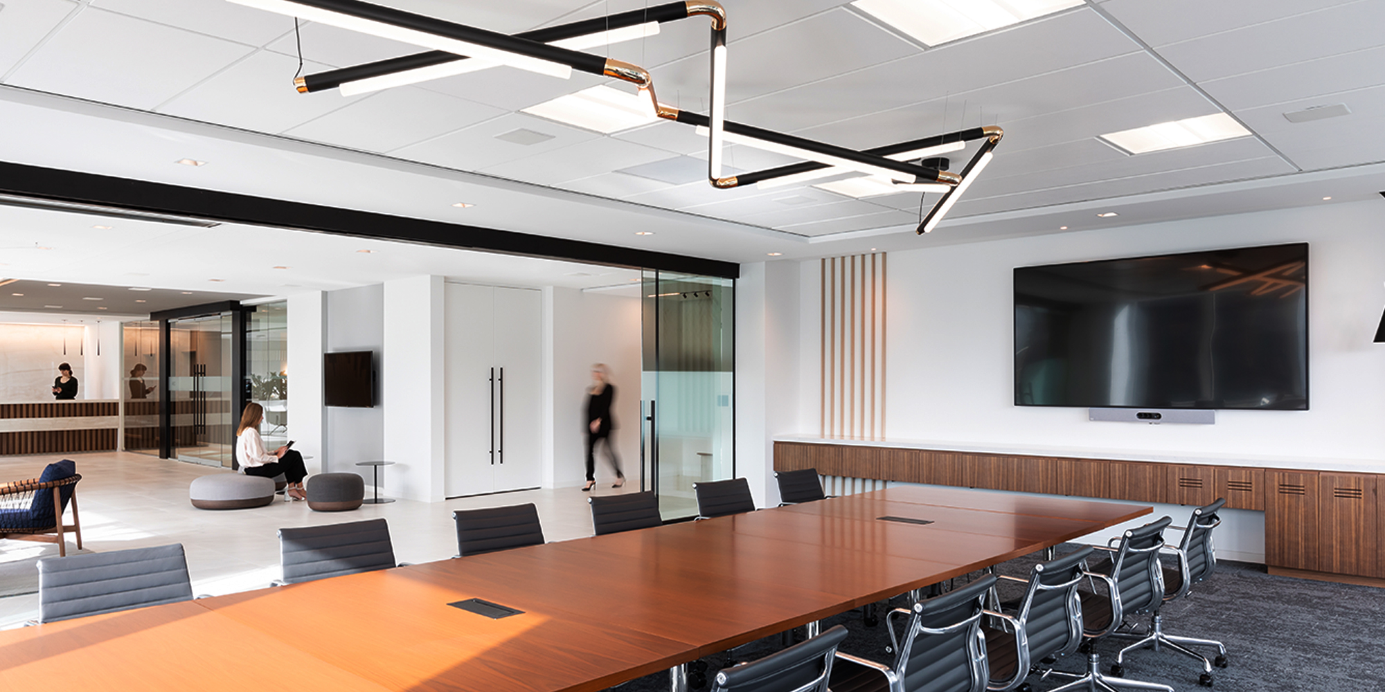 Meeting room with long conference table surrounded by chairs