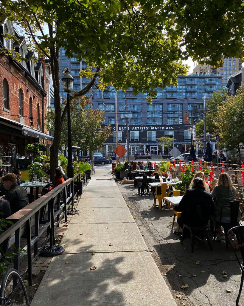 Sidewalk filled with seating for restaurants